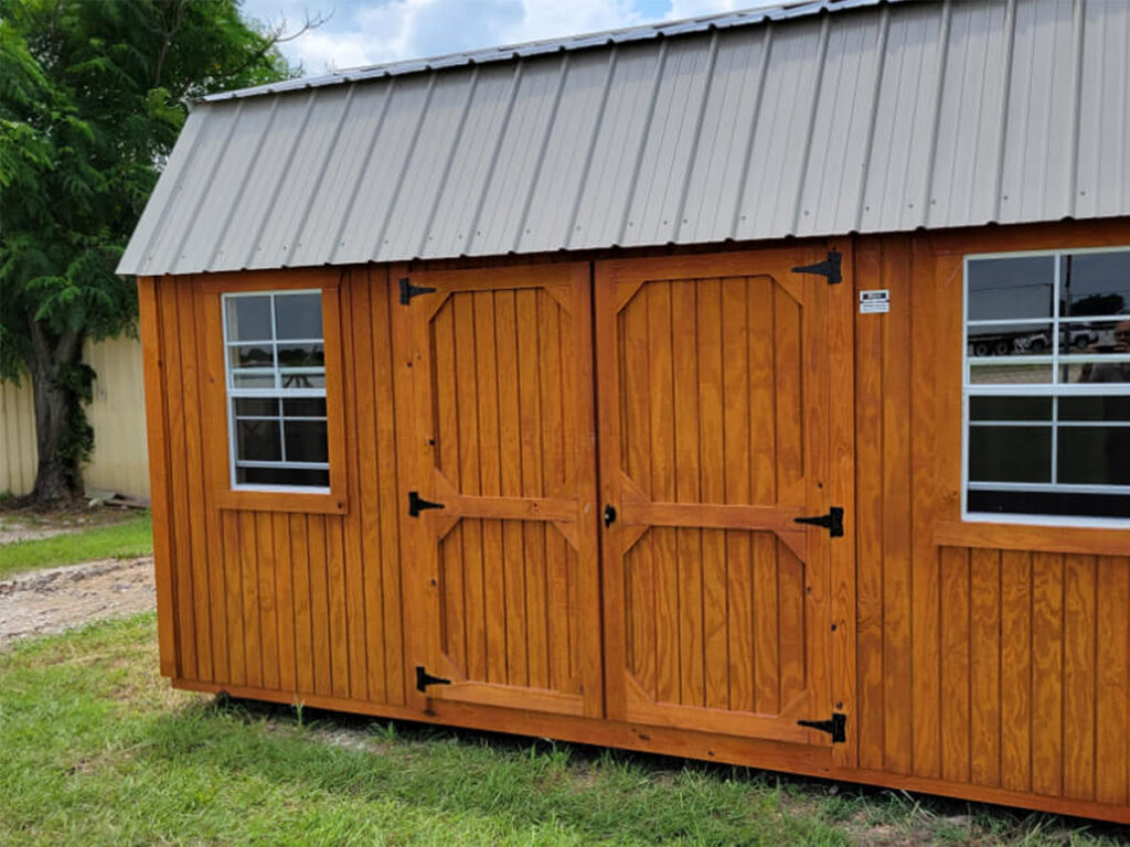 Close up image of a storage shed next to a driveway